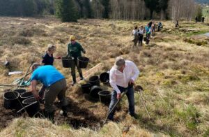 Human chain helping with filling drainage ditches.